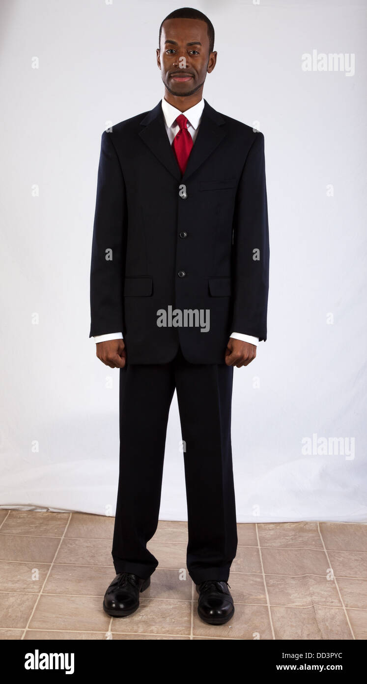 Handsome black man in a suit and red tie, looking at the camera with a  pleasing smile Stock Photo - Alamy