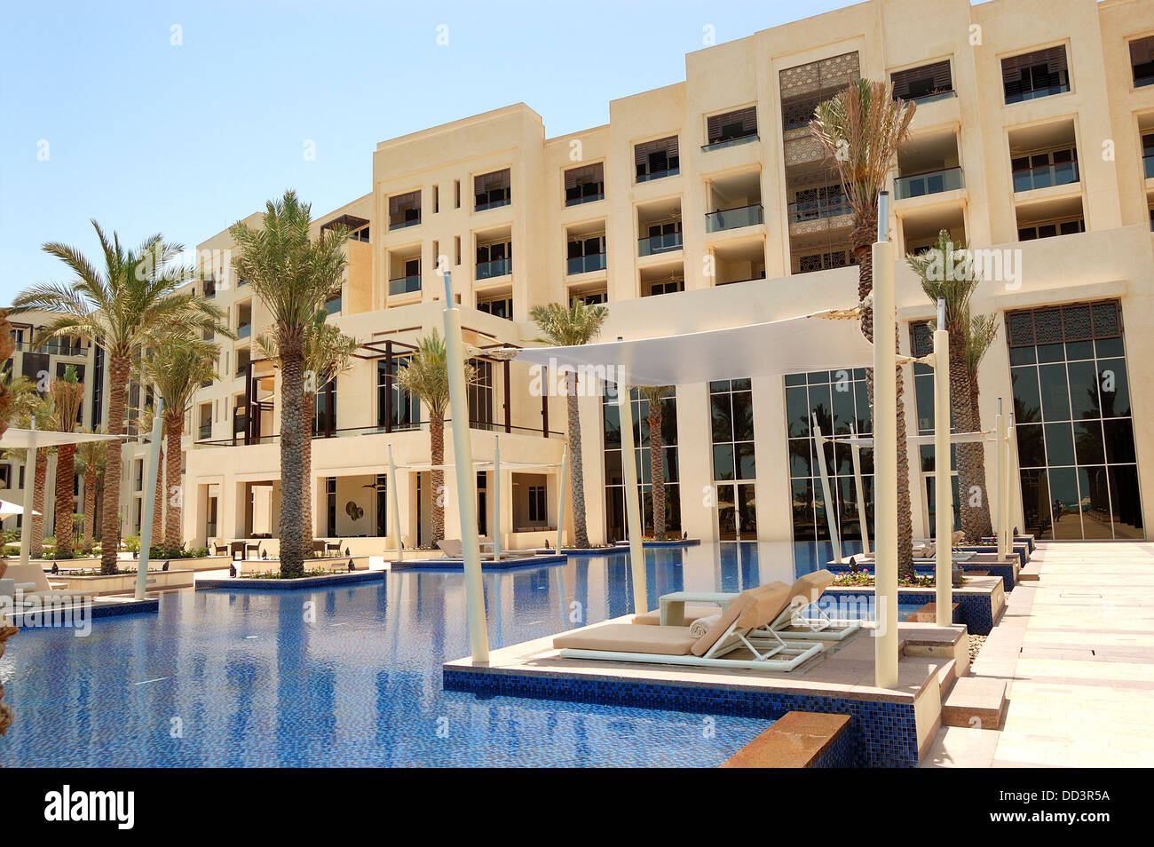 Huts at swimming pool of the luxury hotel, Saadiyat island, Abu Dhabi, UAE Stock Photo
