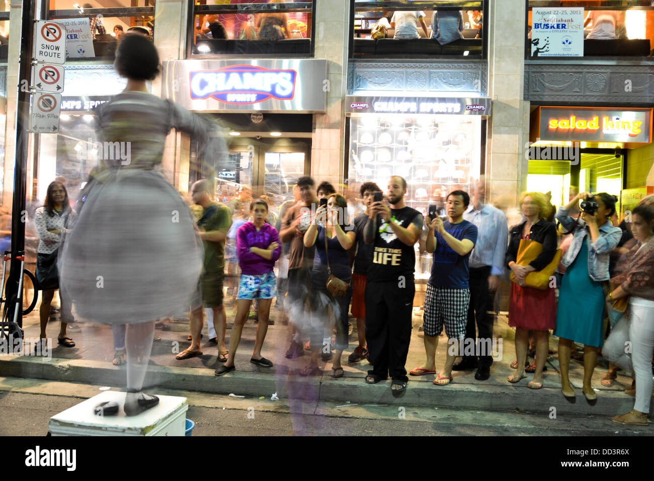 Girl being photograph by people on buskerfest Stock Photo