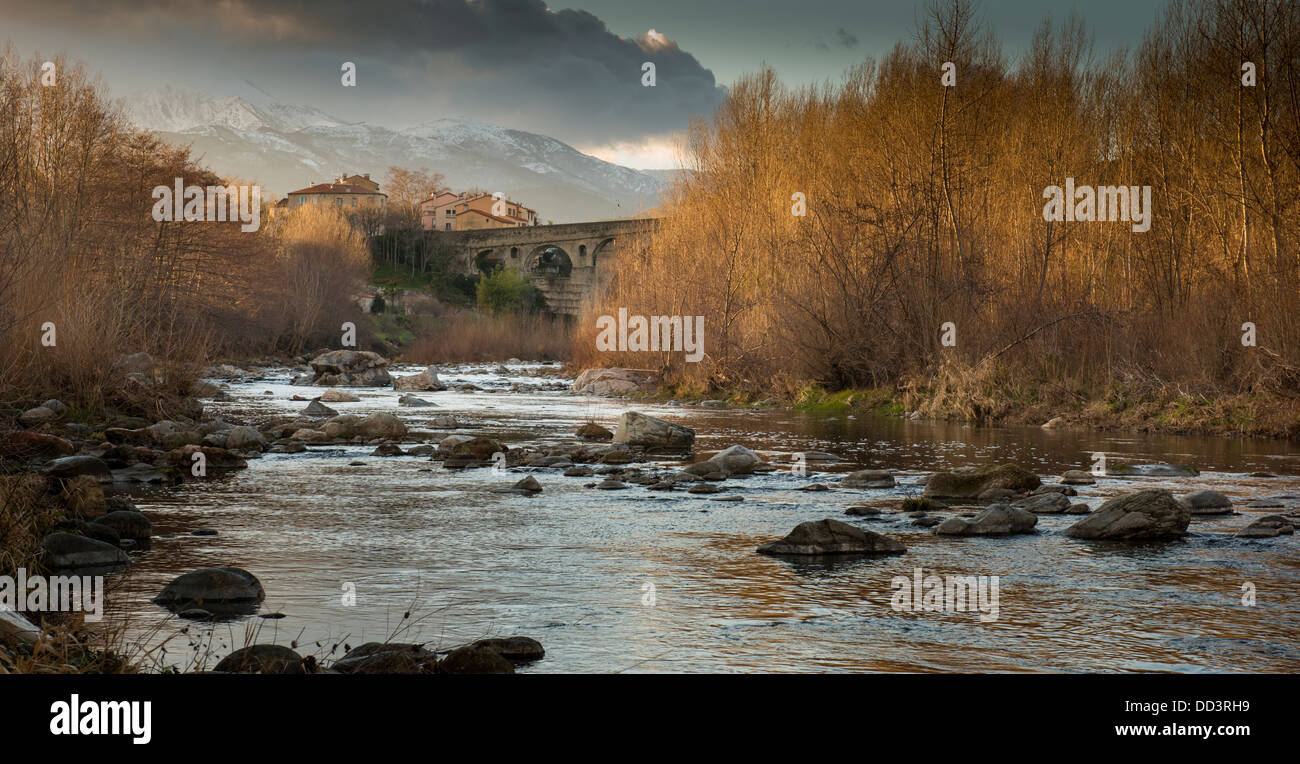 Pont du Diable and River Tech, Ceret, Pyrénées Orientales, Languedoc-Roussillon, France (with Canigou mountain in the background Stock Photo