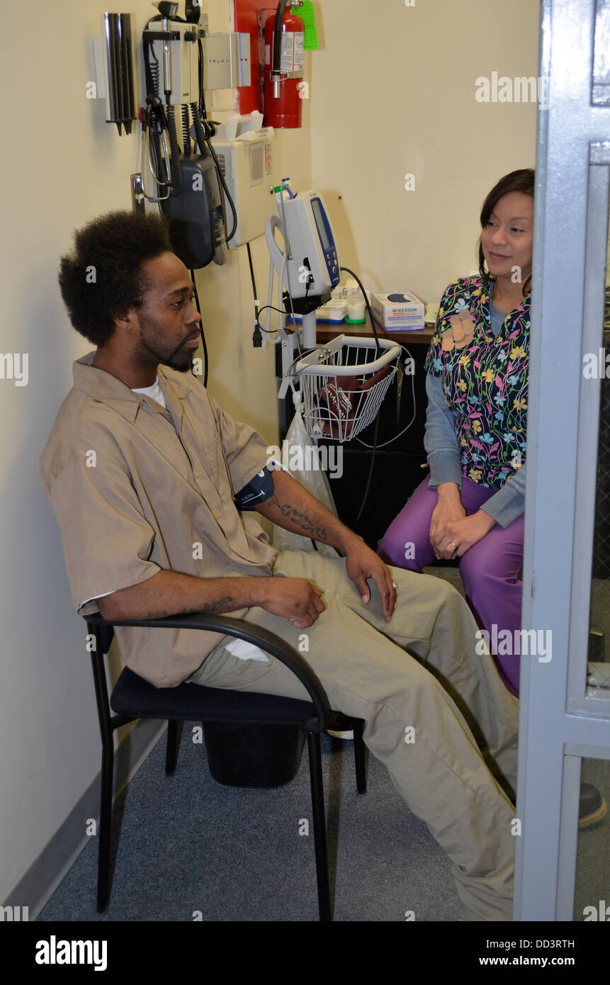 Nurse checking blood pressure of inmate as part of the intake process. Diagnostic & Evaluation Center, Lincoln, Nebraska. Stock Photo