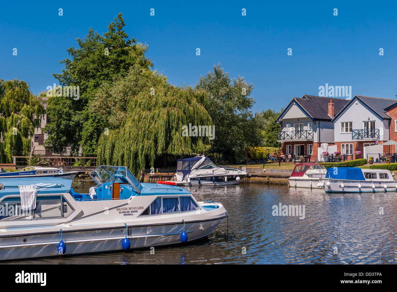Boats and river fronted houses on the river Chet in Loddon , Norfolk