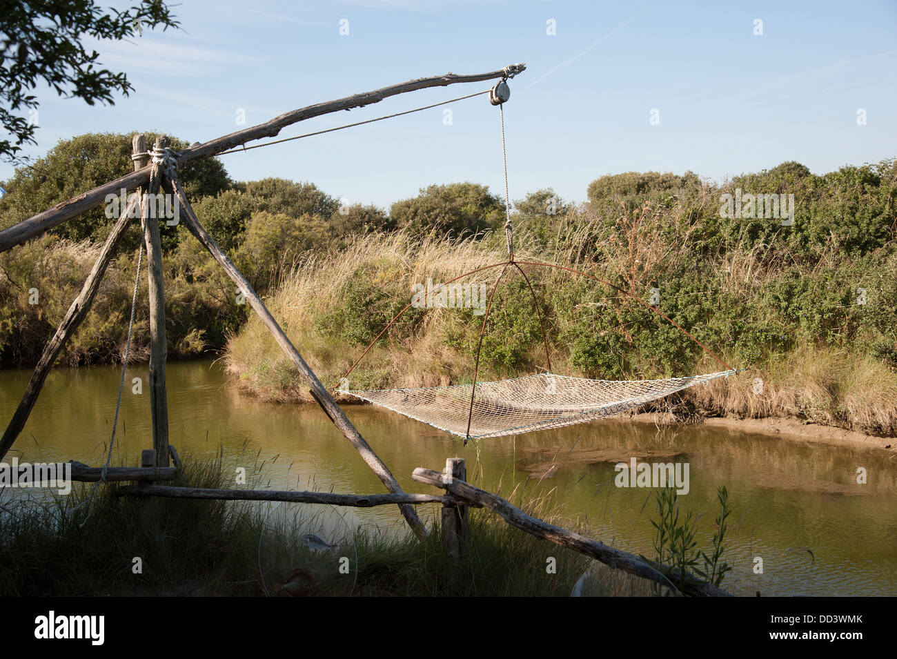 Large fishing net suspended over surface water on a French river Stock  Photo - Alamy
