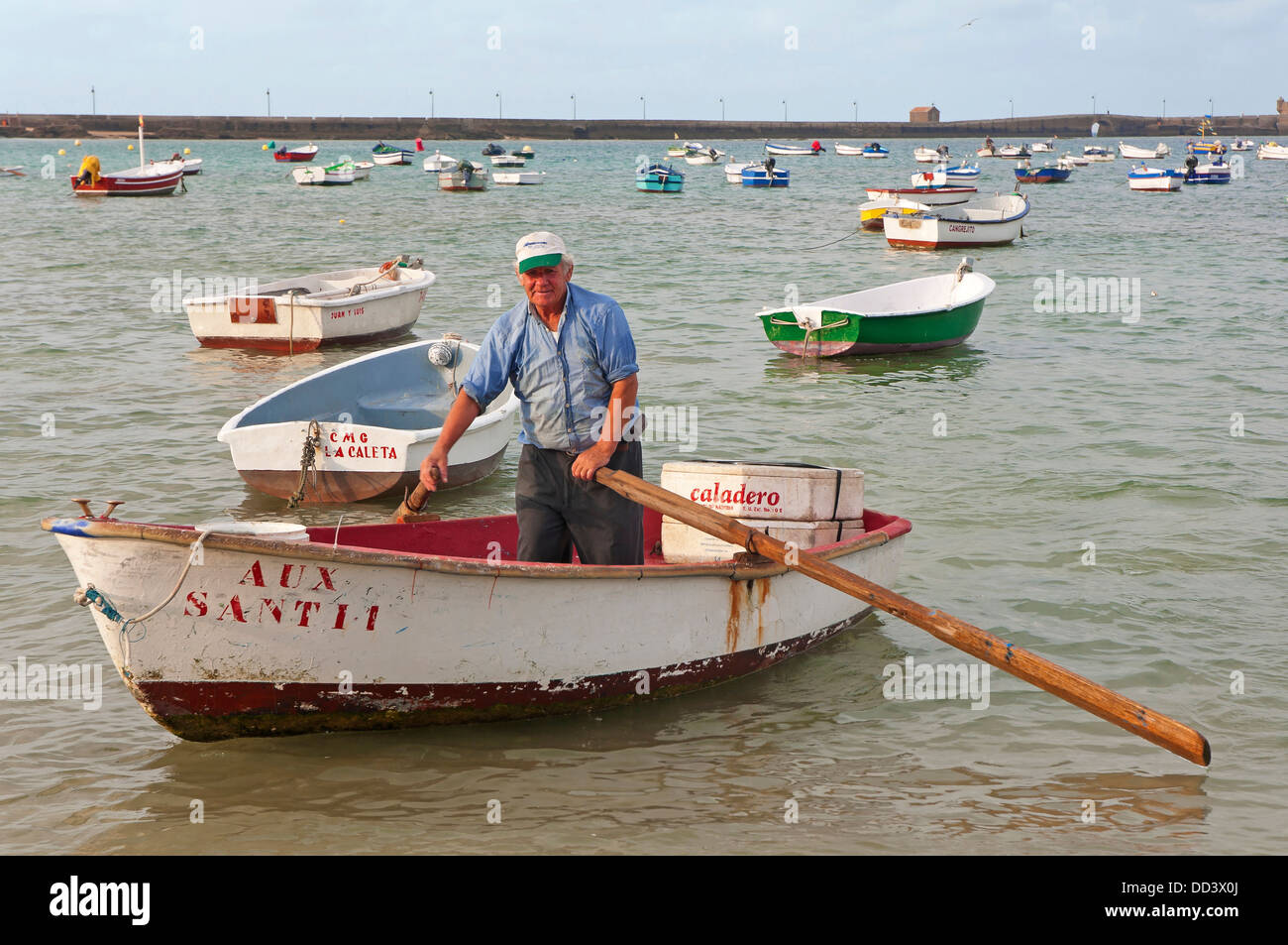 Fisherman in rowboat, La Caleta Beach, Cadiz, Region of Andalusia, Spain, Europe Stock Photo