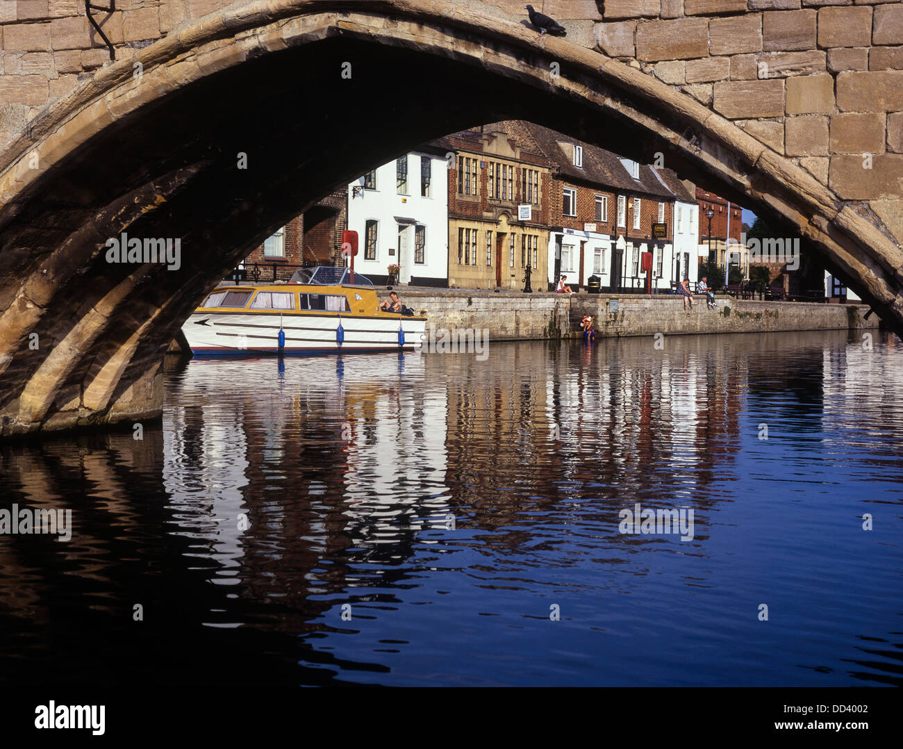 A view of the quay from under the arch of St Ives Bridge. Huntingdonshire. Cambridgeshire Stock Photo
