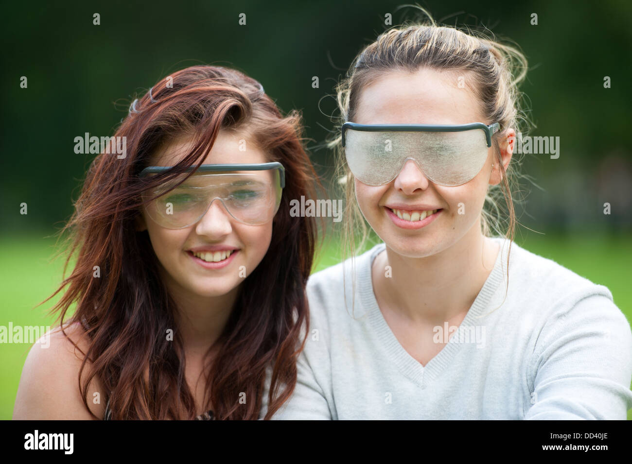 visual impairment simulation glasses worn by two young women Stock Photo