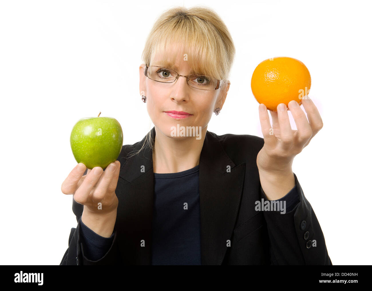 A woman holds and apple and an orange Stock Photo