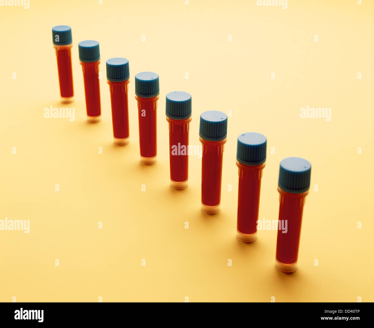 A diagonal row of medical vials filled with blood samples Stock Photo