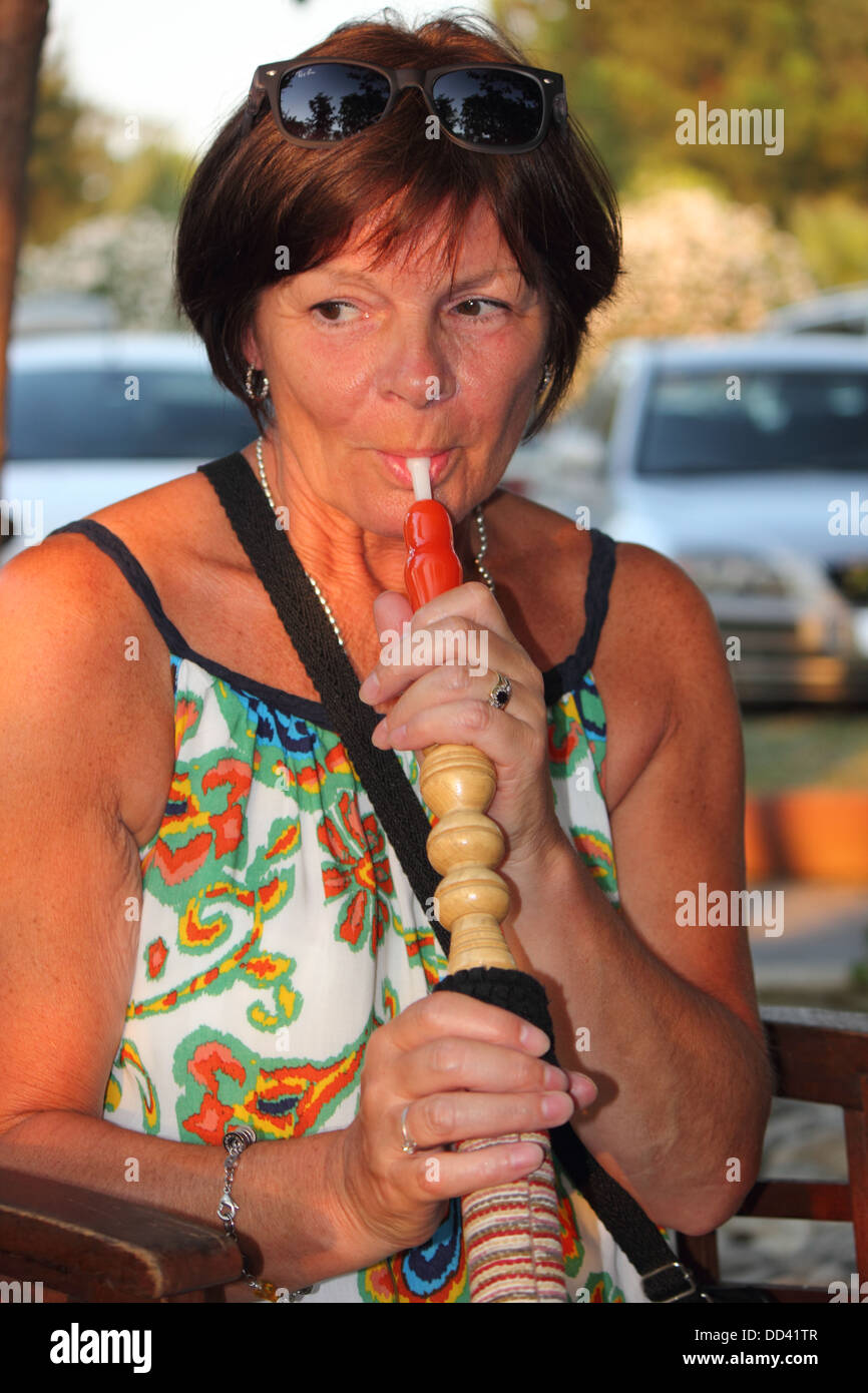 smoking a hookah water pipe Stock Photo Alamy