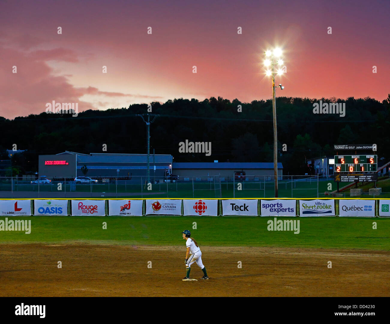 The sun sets on a women's softball game at the Canada Games August 4, 2013 in Sherbrooke, Canada. Stock Photo
