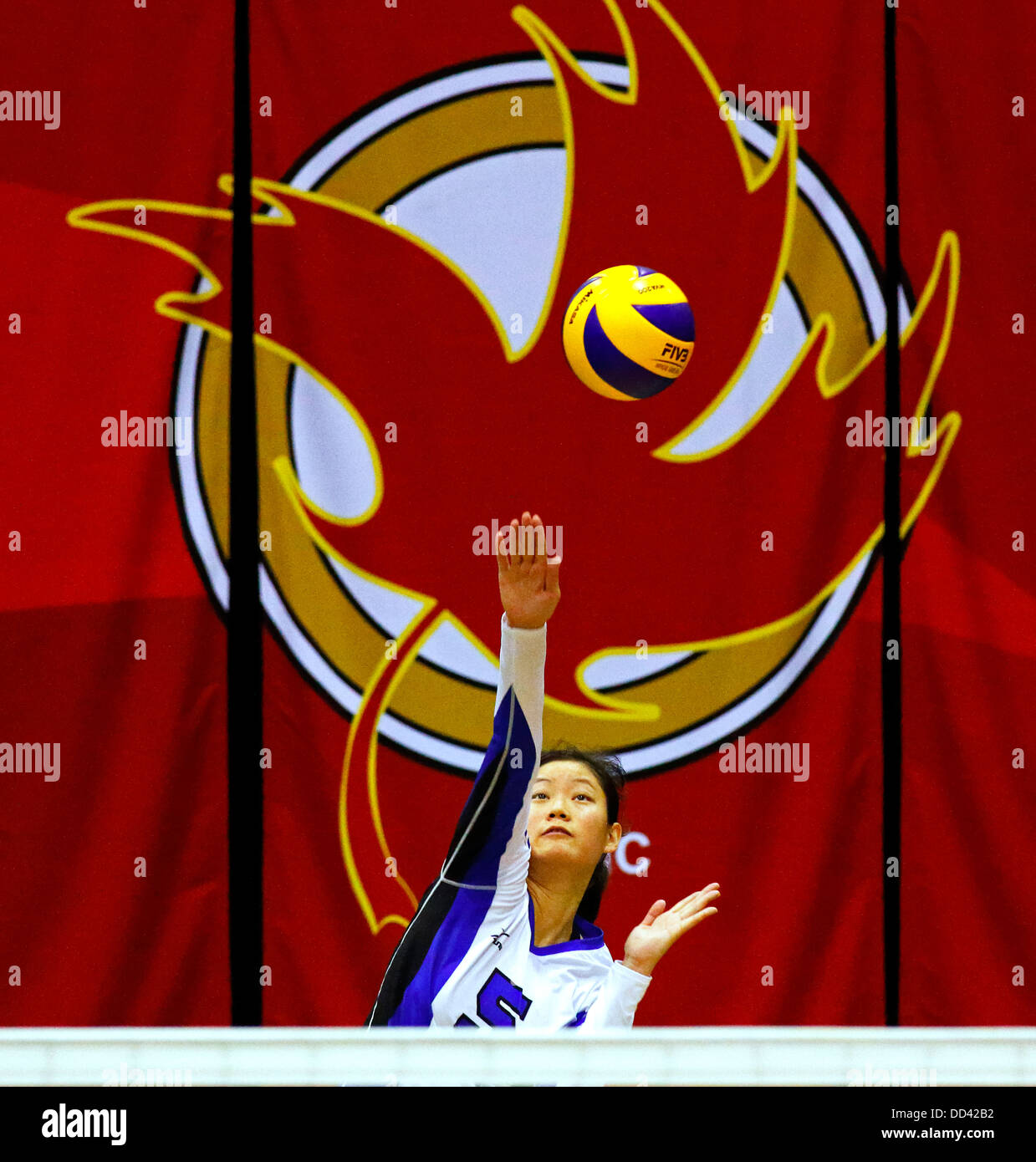 Nova Scotia's Li Maiqi serves in women's volleyball at the Canada Games August 5, 2013 in Sherbrooke, Canada. Stock Photo