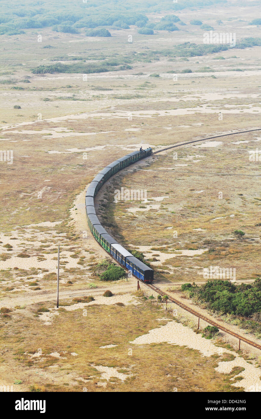 Romney Hythe and Dymchurch Railway train leaving Dungeness Station, taken from a height overlooking Romney Marsh Stock Photo