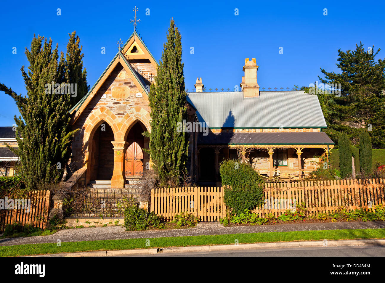 footpath old heritage church buildings main street Clarendon Adelaide Hills South Australia autumn leaves needle pines pencil pi Stock Photo