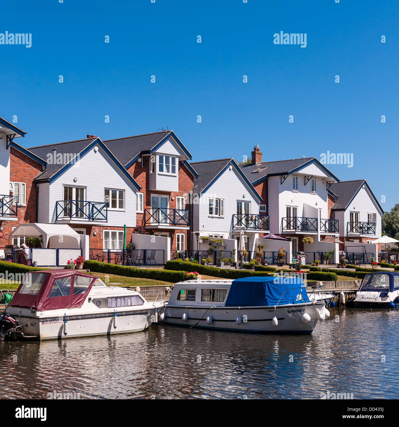 Boats and river fronted houses on the river Chet in Loddon , Norfolk