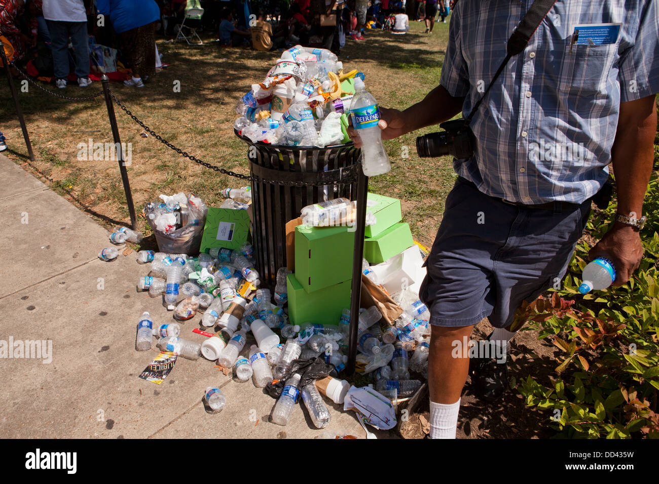 Discarded plastic water bottles overflowing from waste bin - USA Stock Photo