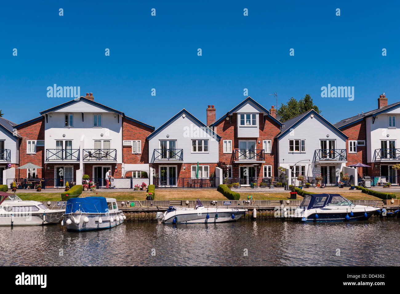 Boats and river fronted houses on the river Chet in Loddon , Norfolk