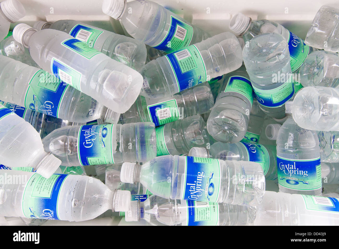 A cooler full of small plastic bottle of drinking water at a disabled