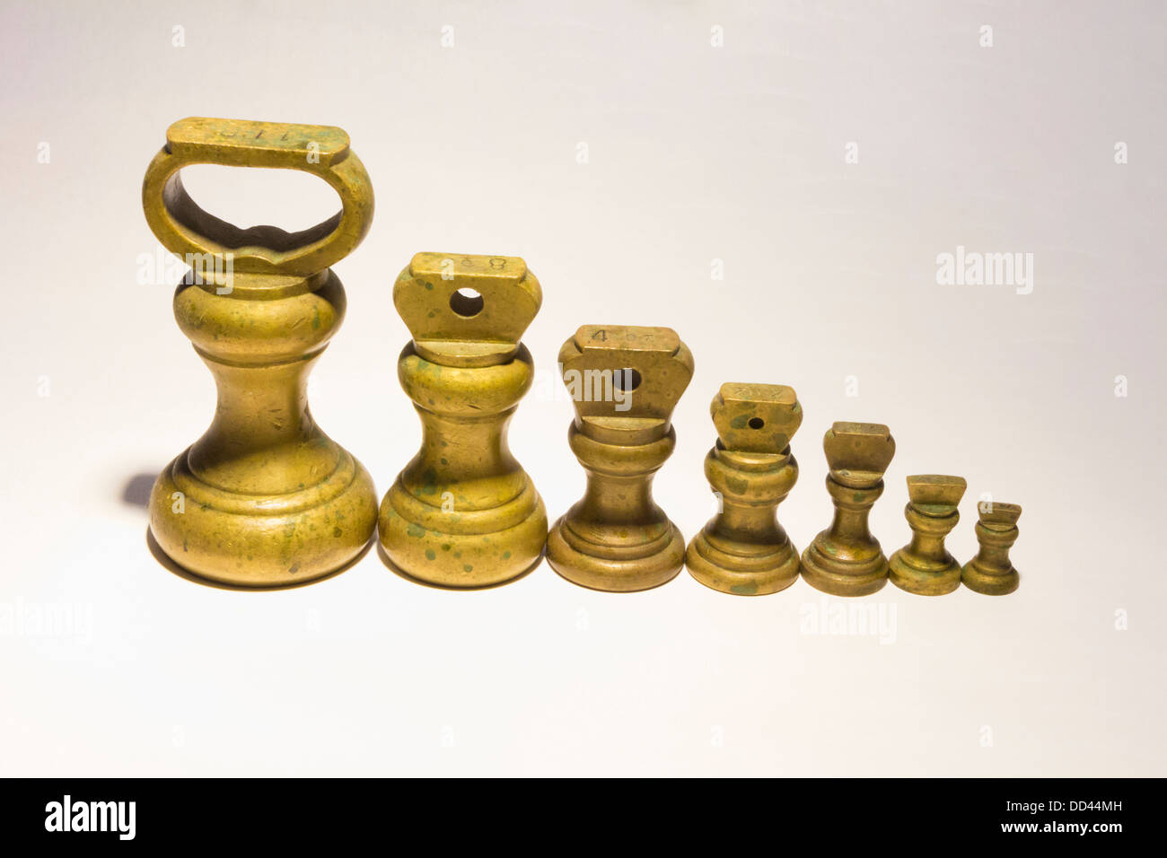 Brass Kitchen weights linedup on white background Stock Photo Alamy