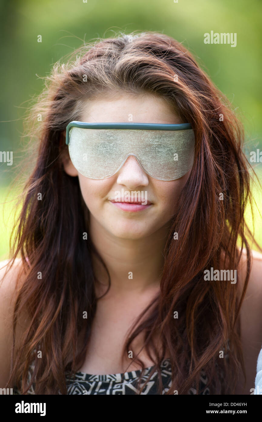 visual impairment simulation glasses worn by a young woman Stock Photo