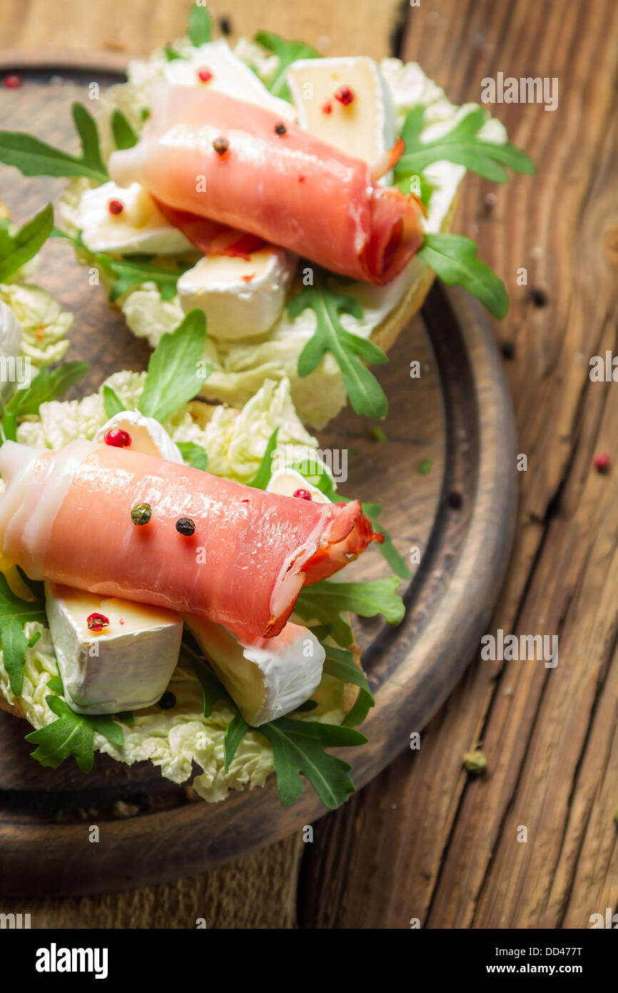 Fresh sandwiches with parma ham, brie cheese and rocket salad Stock