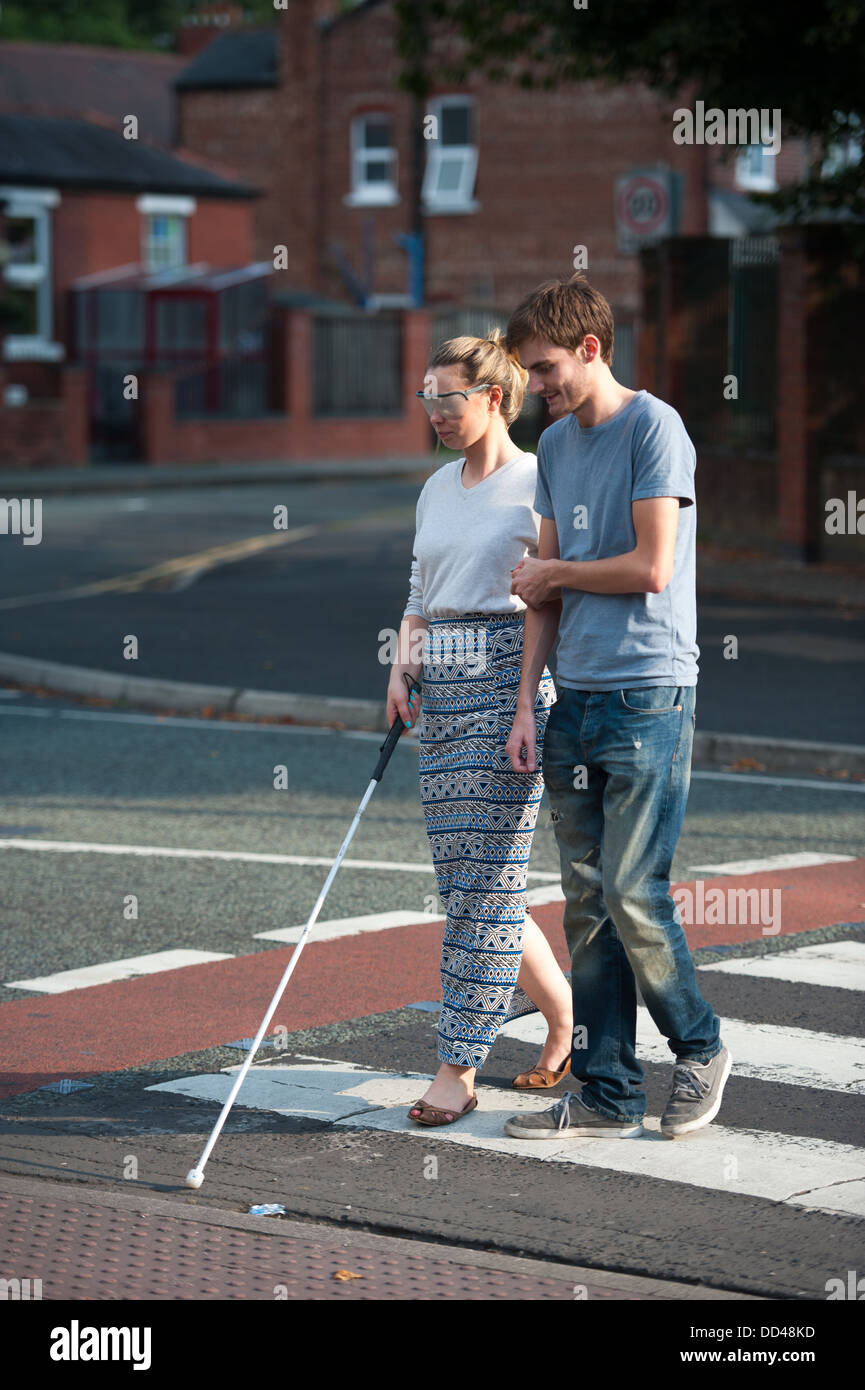 visual impairment simulation glasses training on a zebra crossing Stock Photo