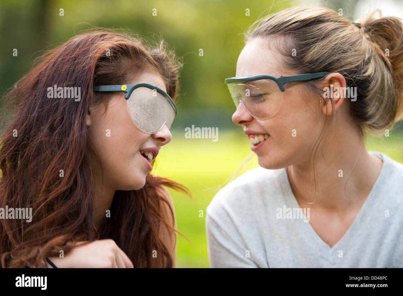 two young people wearing visual impairment simulation glasses Stock Photo