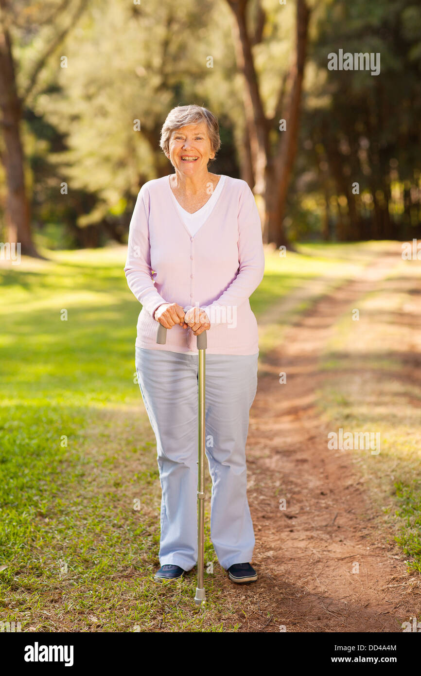 Woman standing park holding white hi-res stock photography and images ...