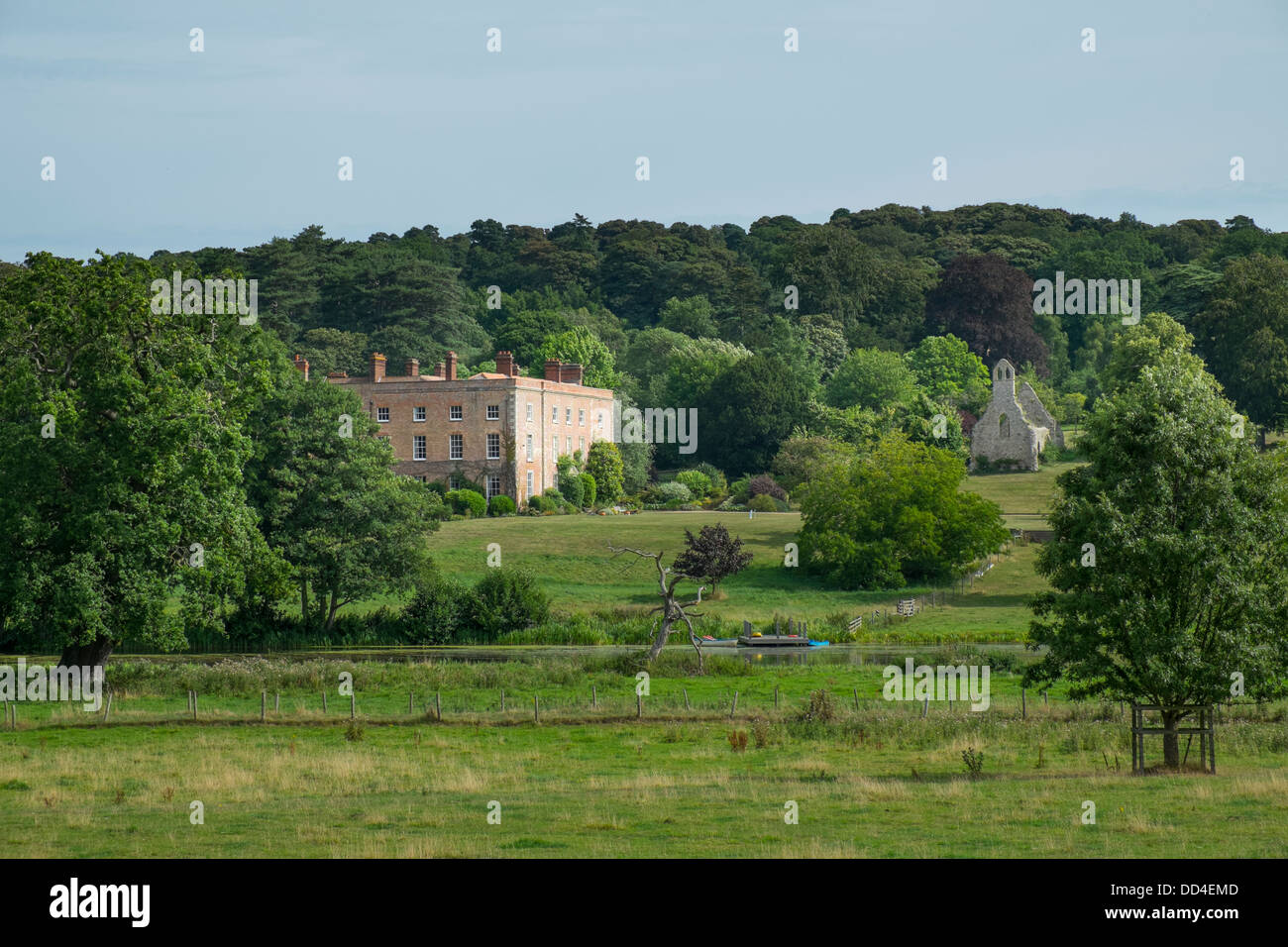 View of Bayfield hall,18th century Georgian country house, showing the ruins of the 11th Century Parish Church of St. Margaret, Stock Photo