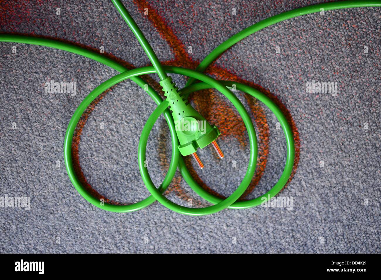 ILLUSTRATION - A green plug with power cable is pictured in Berlin, Germany, 25 August 2013. Photo: Jens Kalaene Stock Photo