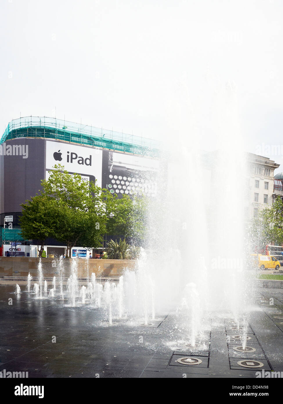 Piccadilly Gardens fountain with iPad commercial in Manchester UK Stock Photo