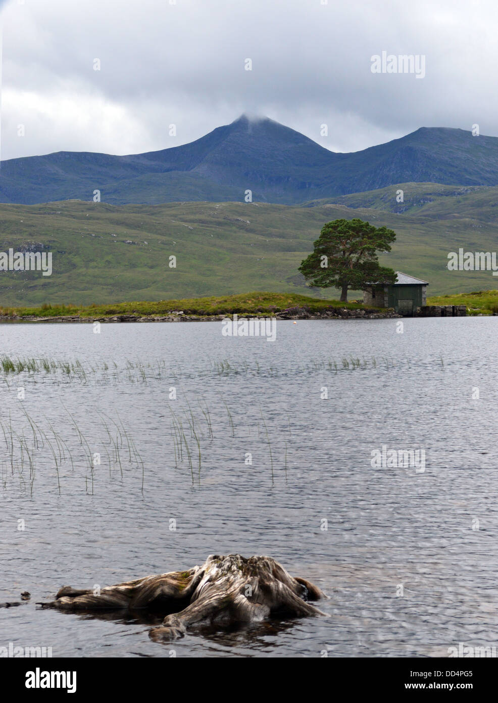 The boat house on Home Loch with Sgurr Mor the tallest of the Fannich Munros in the background. Stock Photo