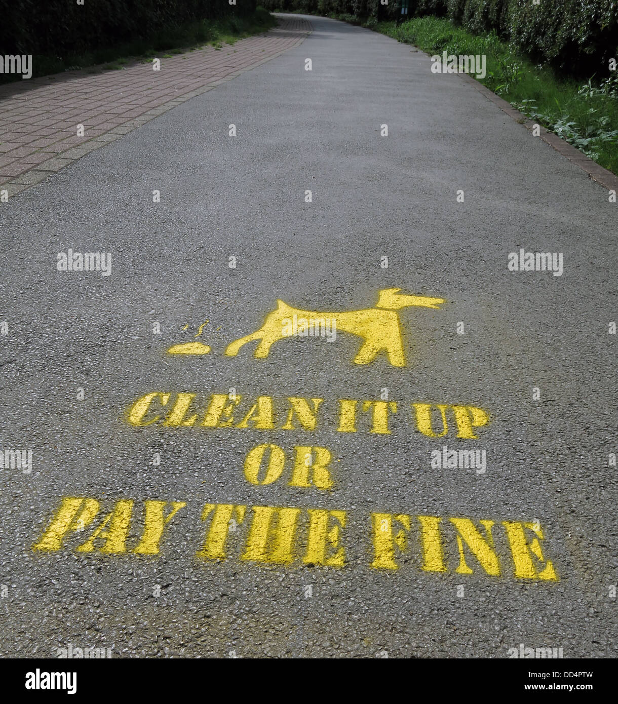 Yellow Clean up your dog mess stencil Warrington Borough Council , Cheshire , England , UK Stock Photo
