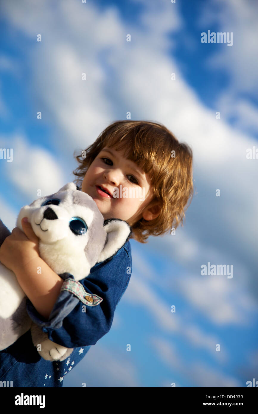 Pretty Toddler Girl with Teddy in Blue Sky Stock Photo