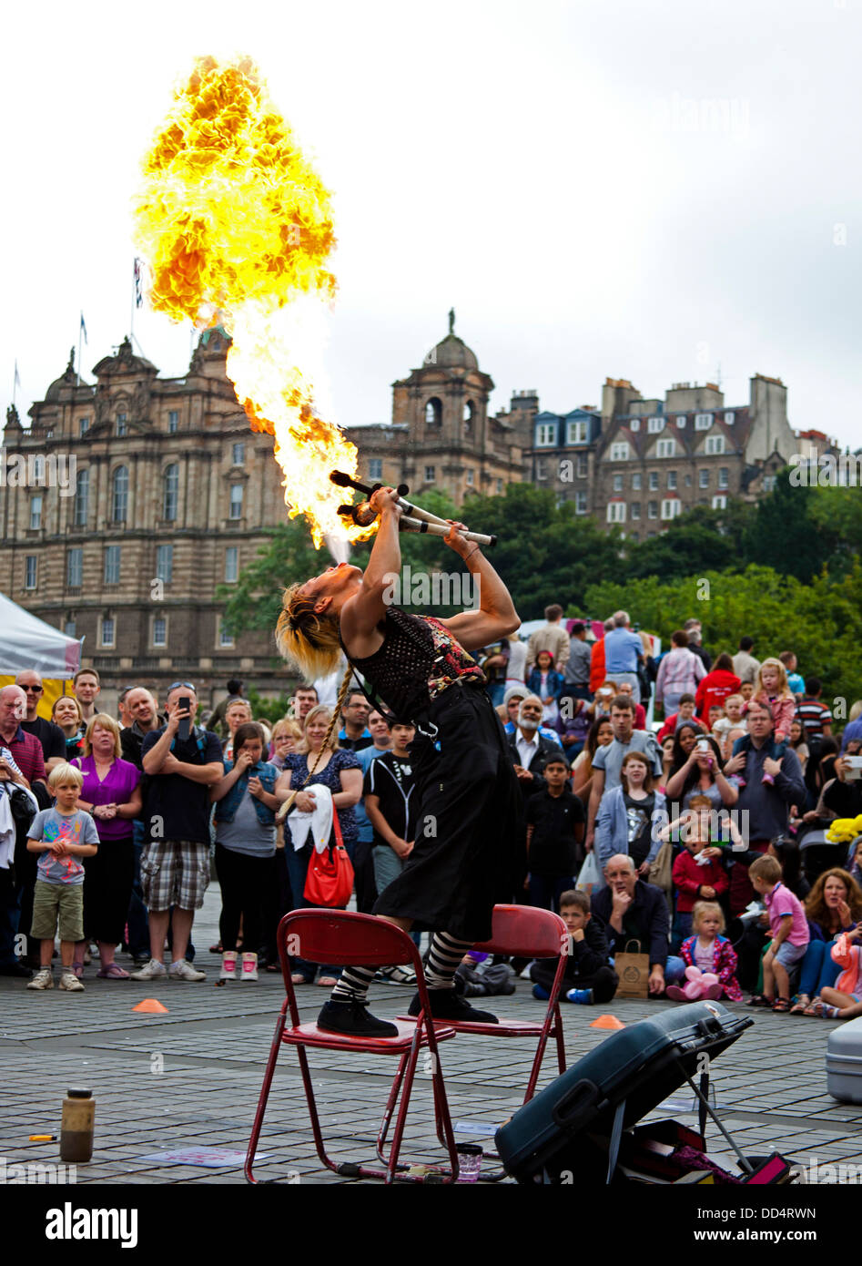 Edinburgh Fringe Festival Japanese street entertainer blowing ball of fire Mound Scotland UK Stock Photo