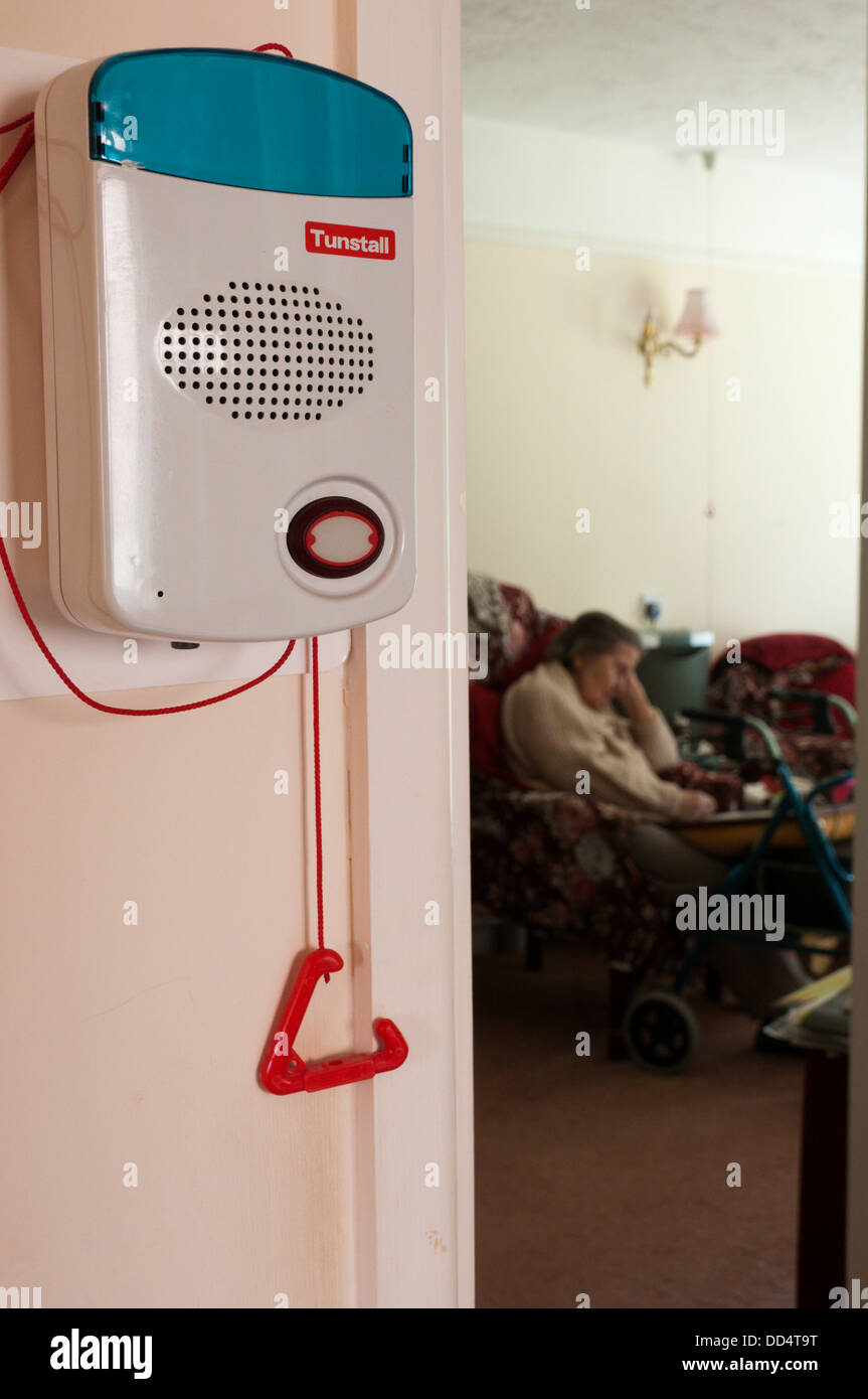 An old lady sleeps in her warden assisted bungalow with a warden call alarm system and pull cord for any emergency. Stock Photo