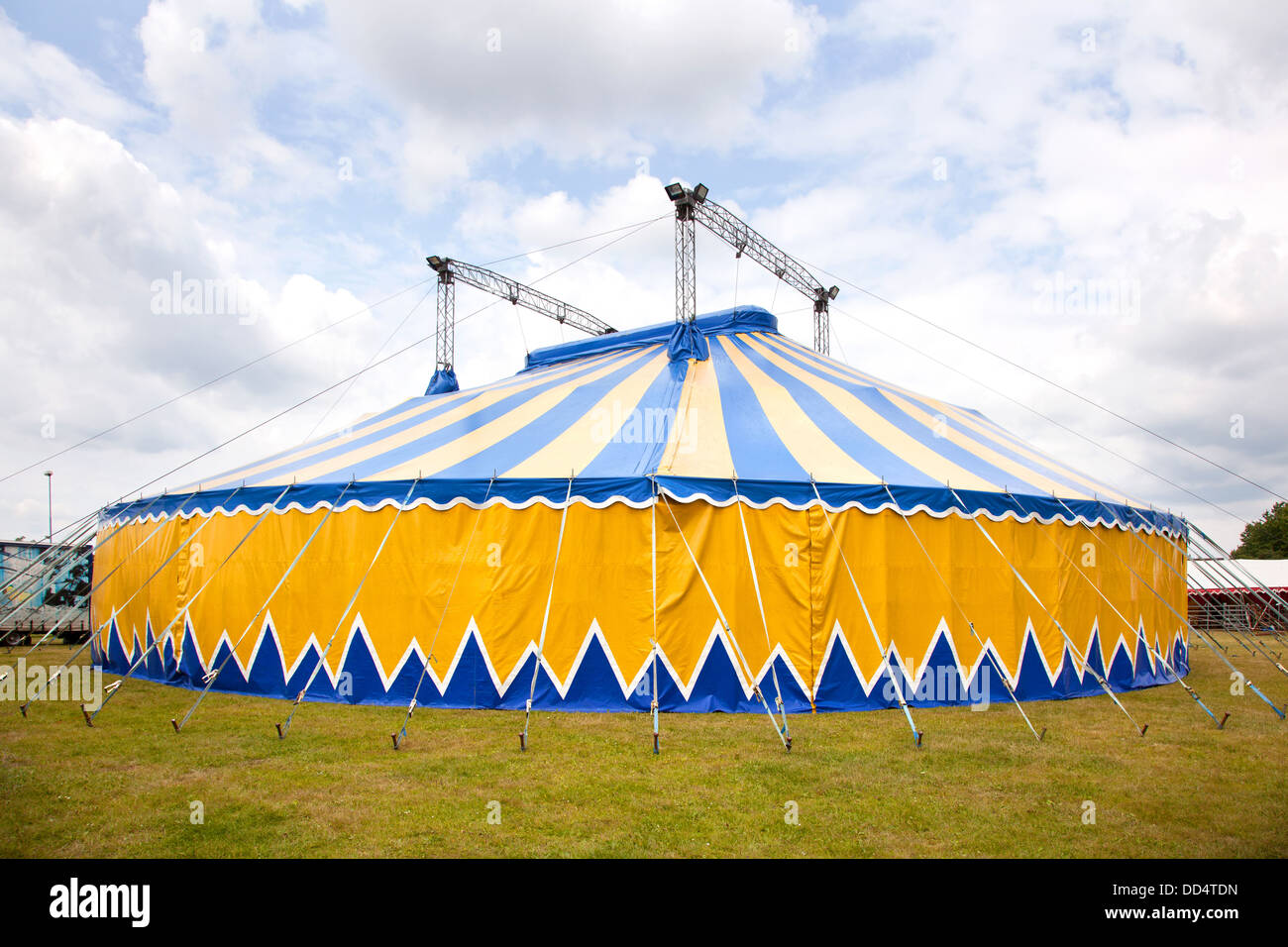 circus tent in yellow and blue in the grass Stock Photo