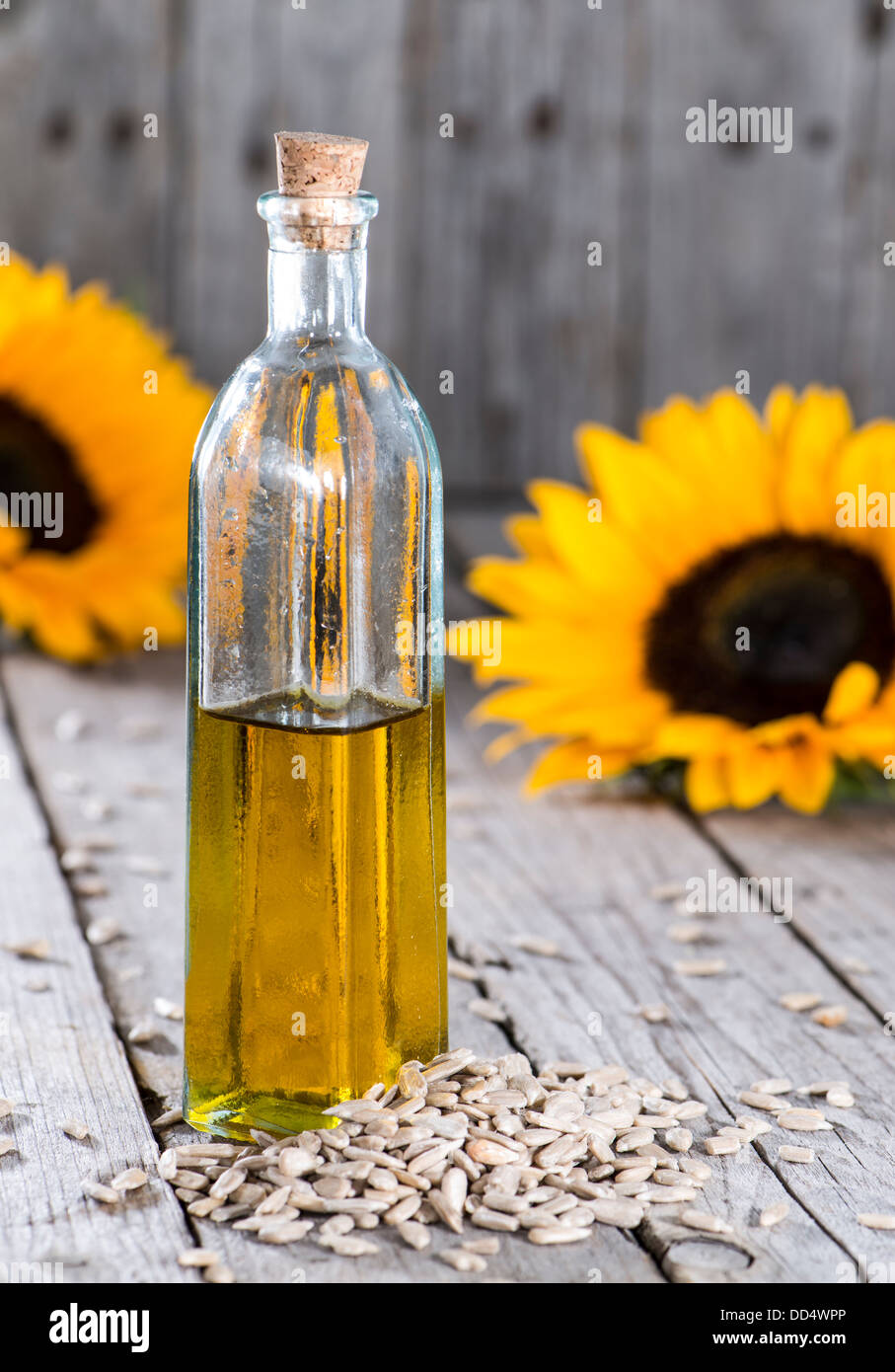 Sunflower Oil with seeds on vintage wooden background Stock Photo