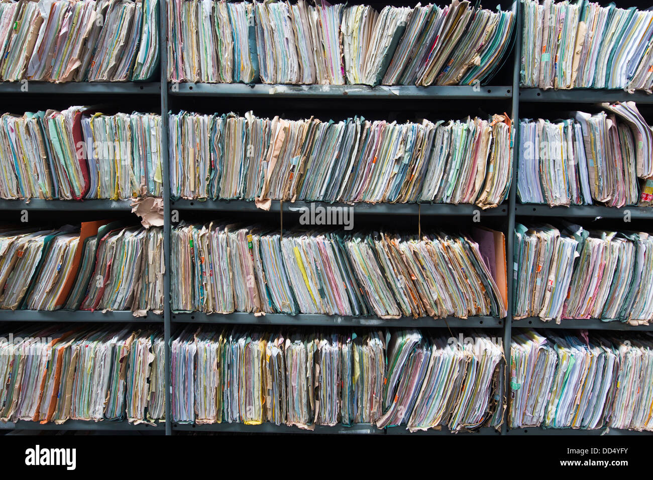 Shelves in a warehouse stuffed with office paperwork, folders and files which have now been transcribed on to digital storage. Stock Photo