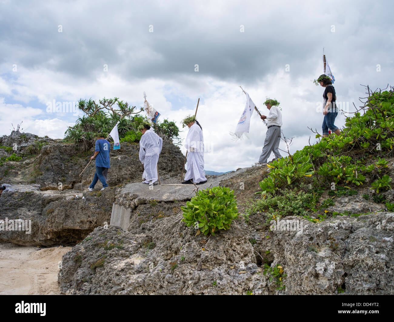 Village elders make their way to the beach to leads prayers at Unjami Festival on Kouri Island, Okinawa Stock Photo