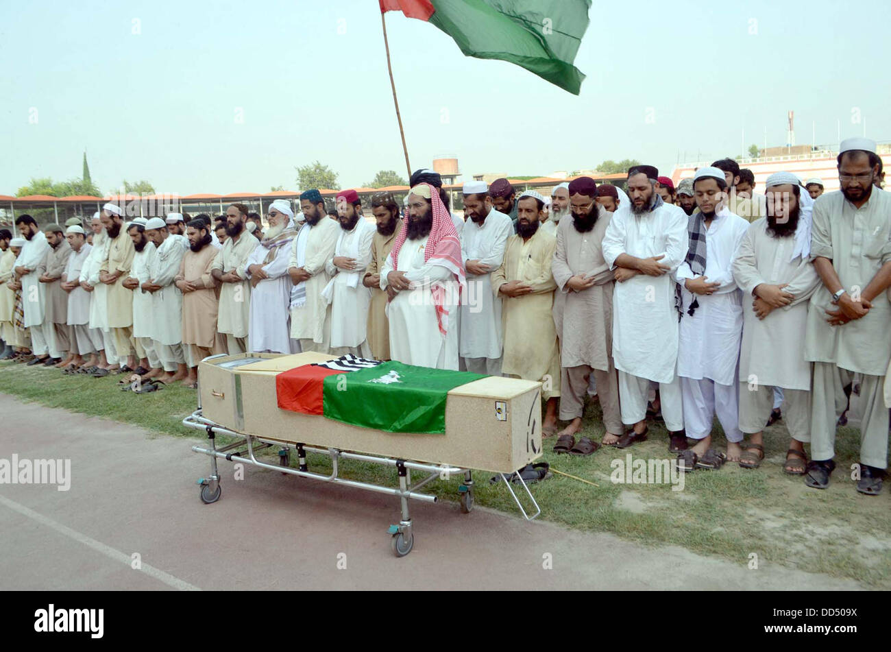 Activists of Ahle Sunnat Wal Jamat offering funeral prayer of their leader and spokesman, Akbar Saeed Farooqi who gunned down by unidentified gunmen in Gulshan-e-Iqbal on Sunday in Karachi, on Qayyum Stadium in Peshawar on Monday, August 26, 2013. Stock Photo