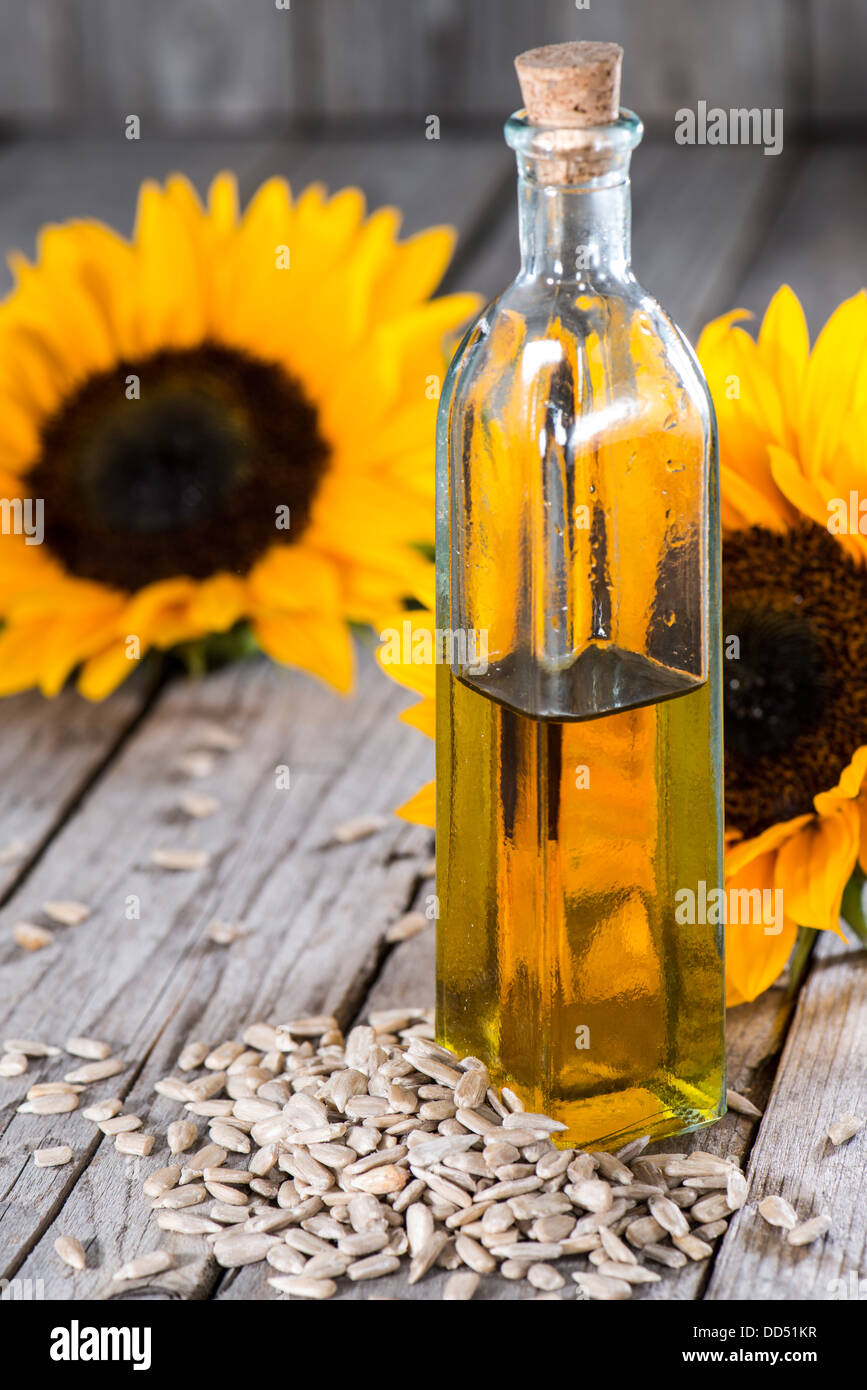 Fresh Sunflower Oil on wooden background Stock Photo