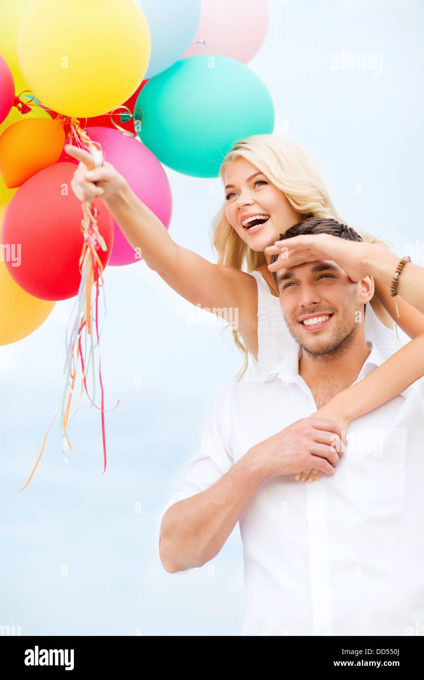 couple with colorful balloons at seaside Stock Photo - Alamy