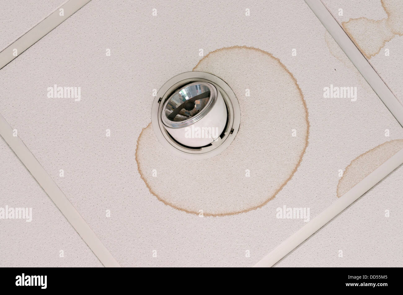 Watermark stain on ceiling where water has been leaking onto and around