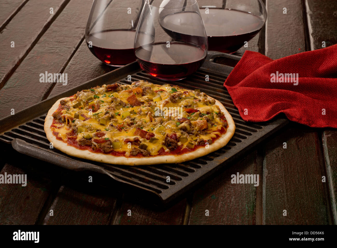 Cheeseburger Pizza as an appetizer with red wine. Stock Photo