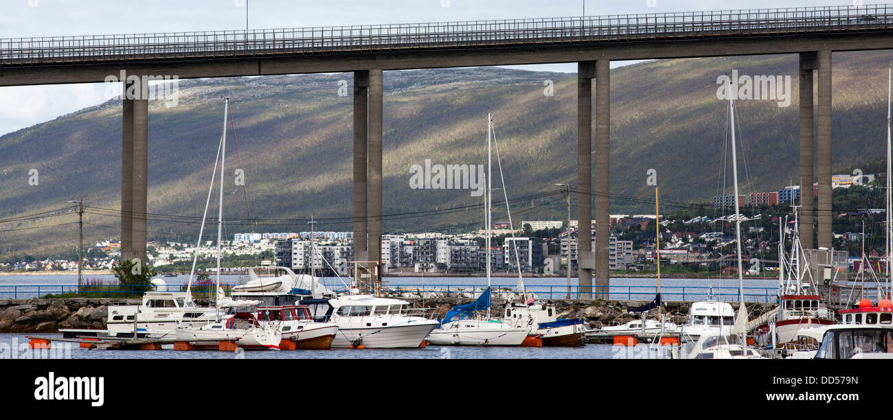 Tromso bridge with a fell in the background and sailing boats at the harbour Stock Photo