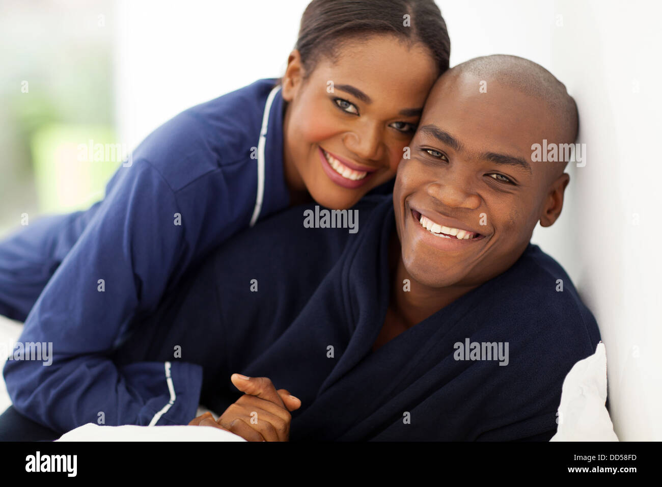 portrait of happy African couple in nightwear on bed Stock Photo - Alamy