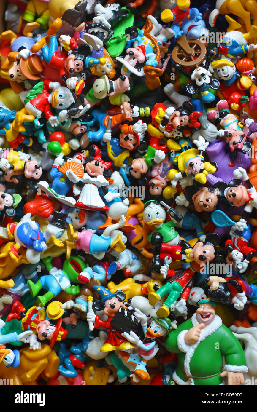 a large collection of colorful vintage Disney pvc toy figures, including Mickey Mouse, Minnie, Donald Duck, Goofy, Pluto Stock Photo