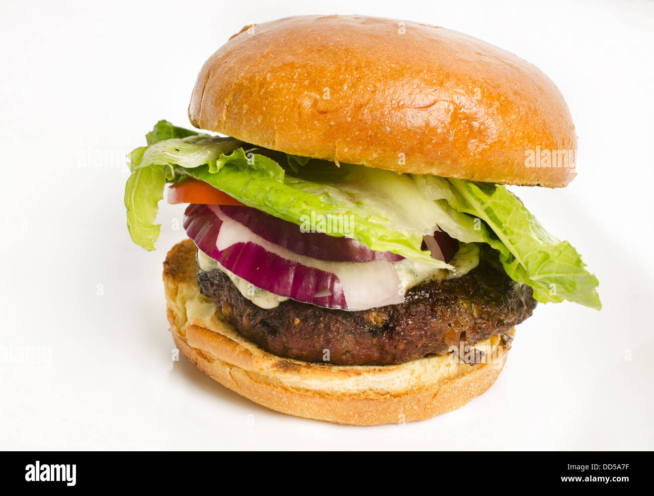 Delicious juicy cheese burger isolated against white background. Stock Photo