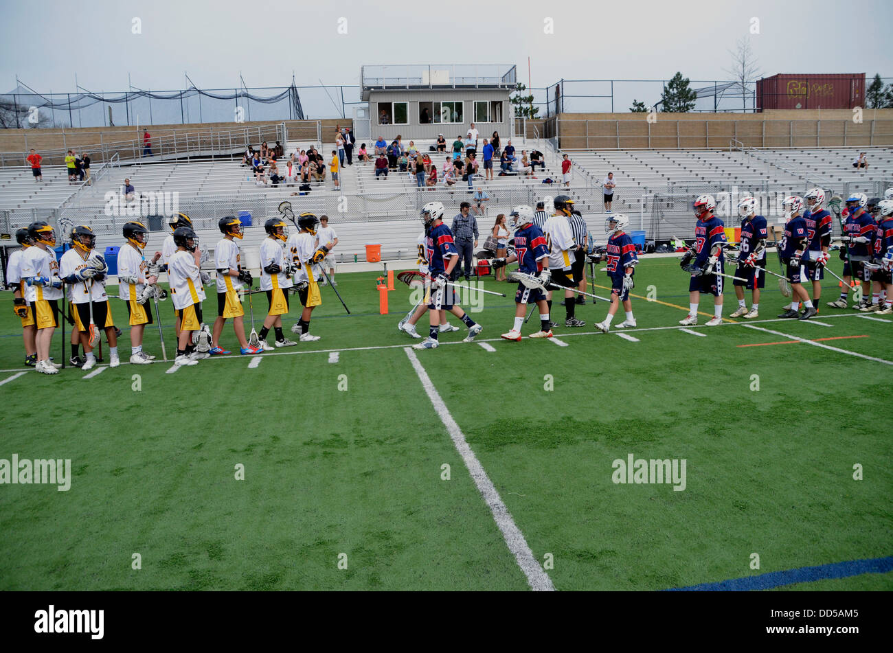 High school lacrosse team players congratulate each other for a game