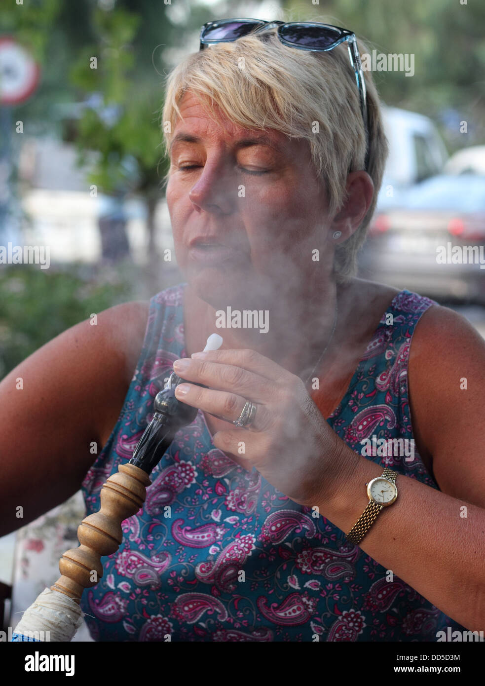 smoking a hookah water pipe Stock Photo
